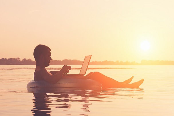 guy on laptop beach